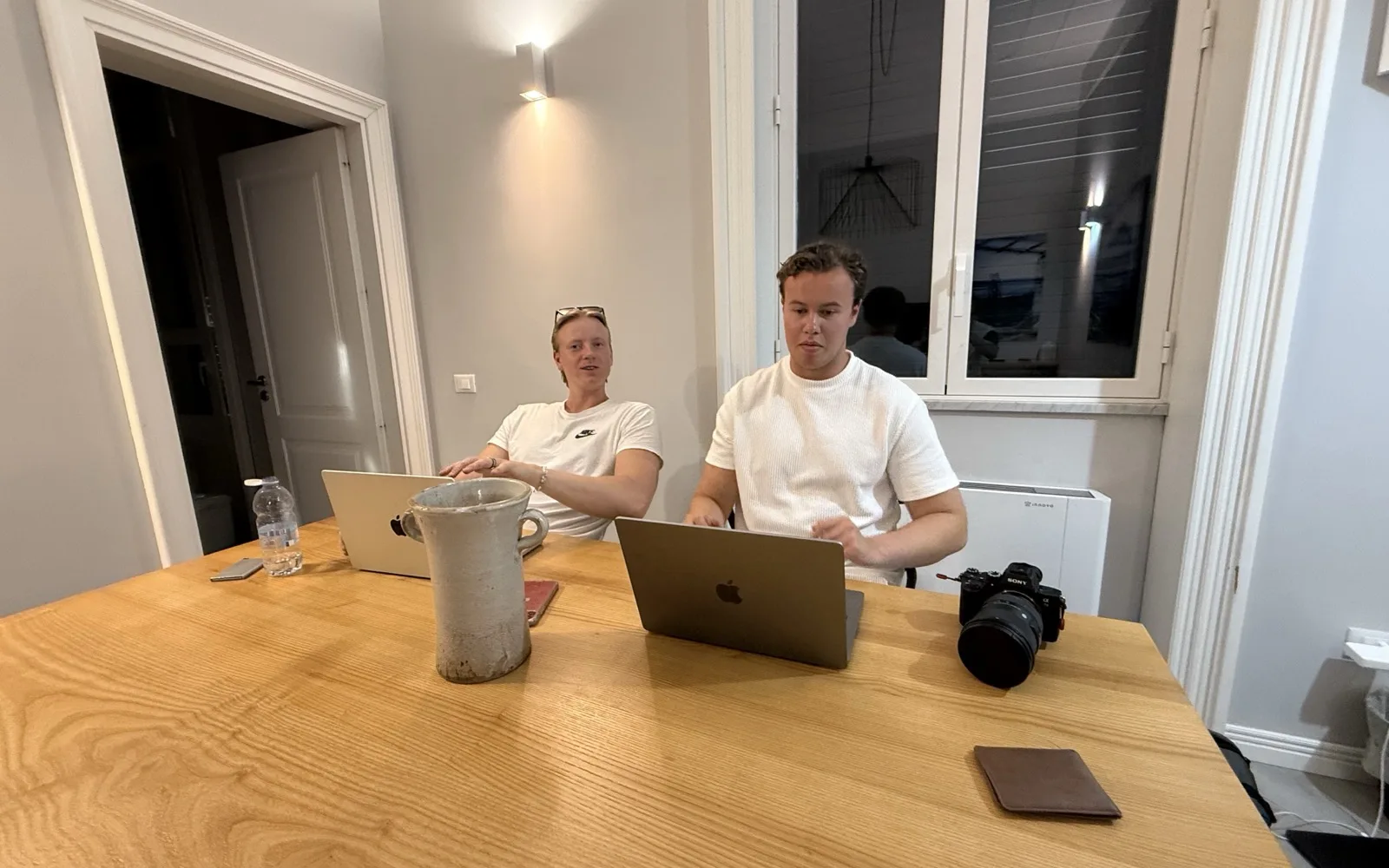 Two of the Enthemed team working late around the table at the office.