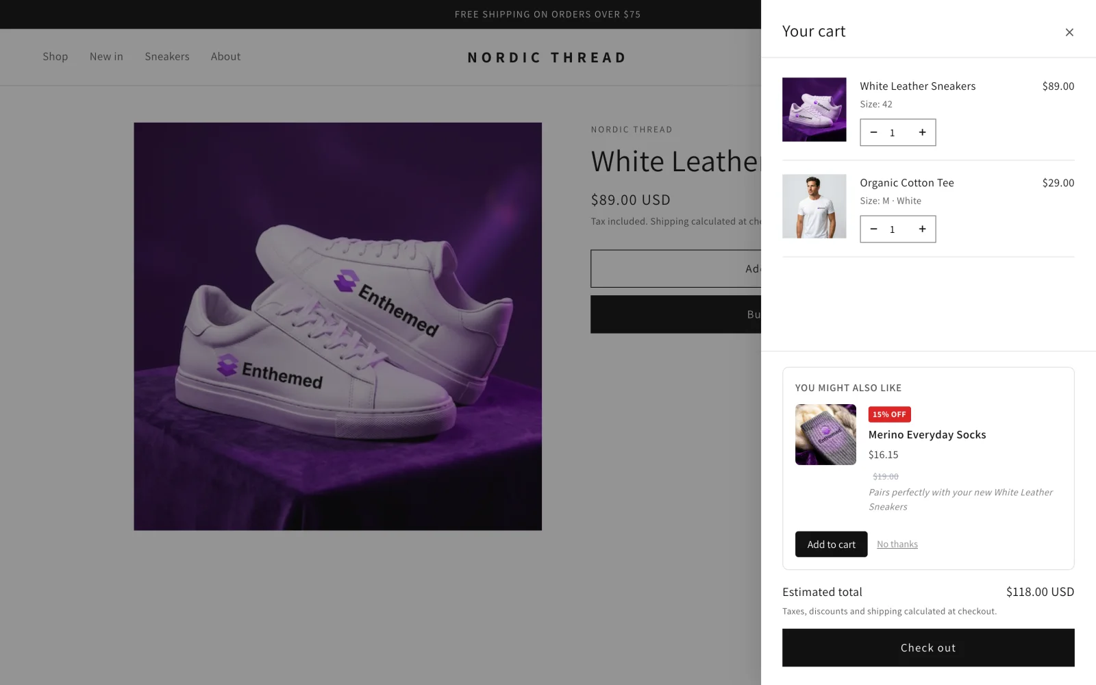 A cart drawer suggesting Merino Everyday Socks at 15% off to go with White Leather Sneakers.